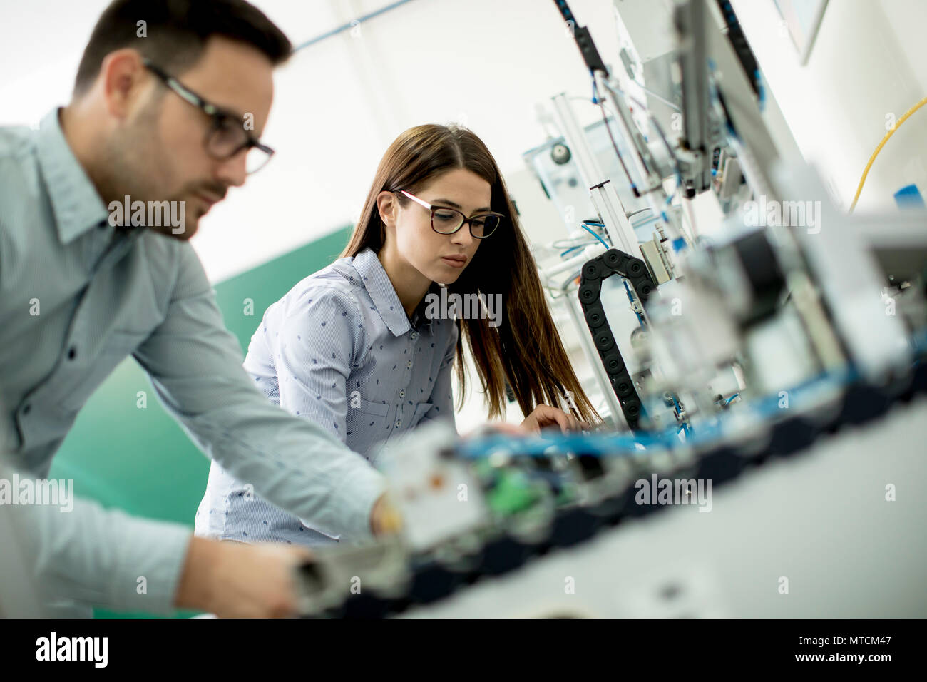 Young couple of students working at robotics lab Stock Photo