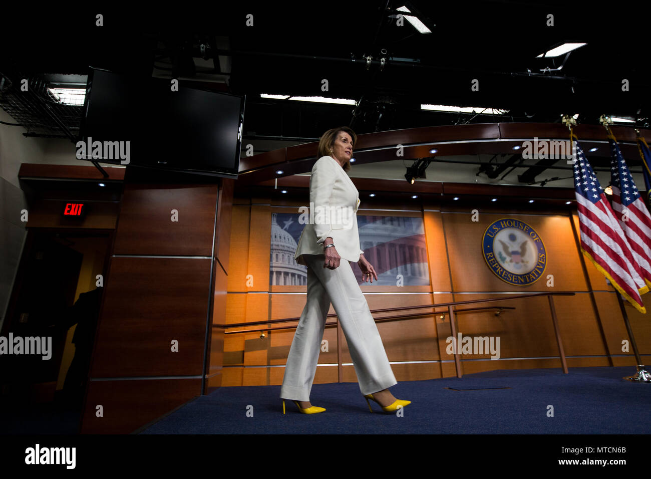 Democratic Leader Rep. Nancy Pelosi (D-CA) walks to the podium during her weekly press conference at the U.S. Capitol. Stock Photo