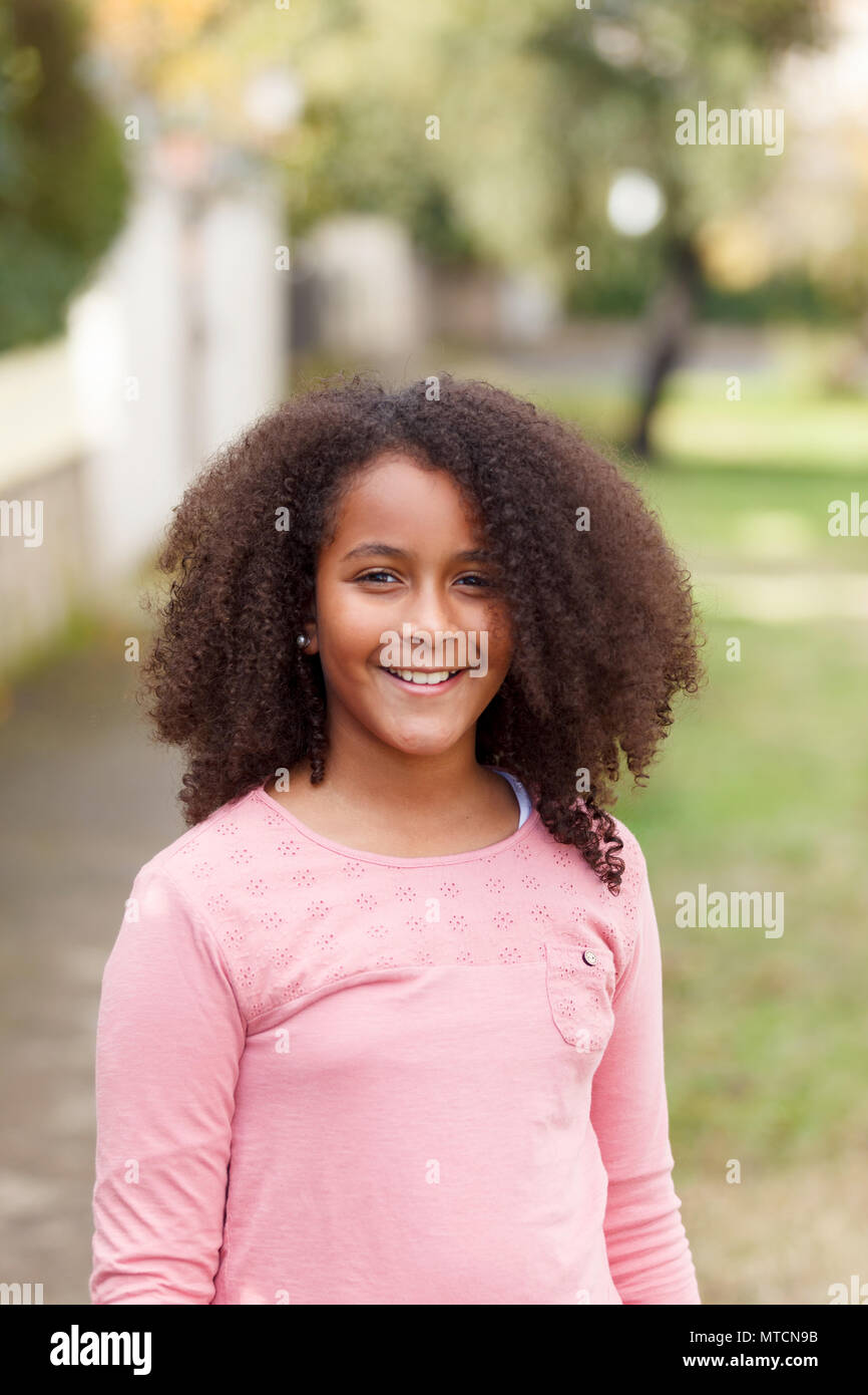 Cute African American Girl Smiling In The Street With Afro Hair