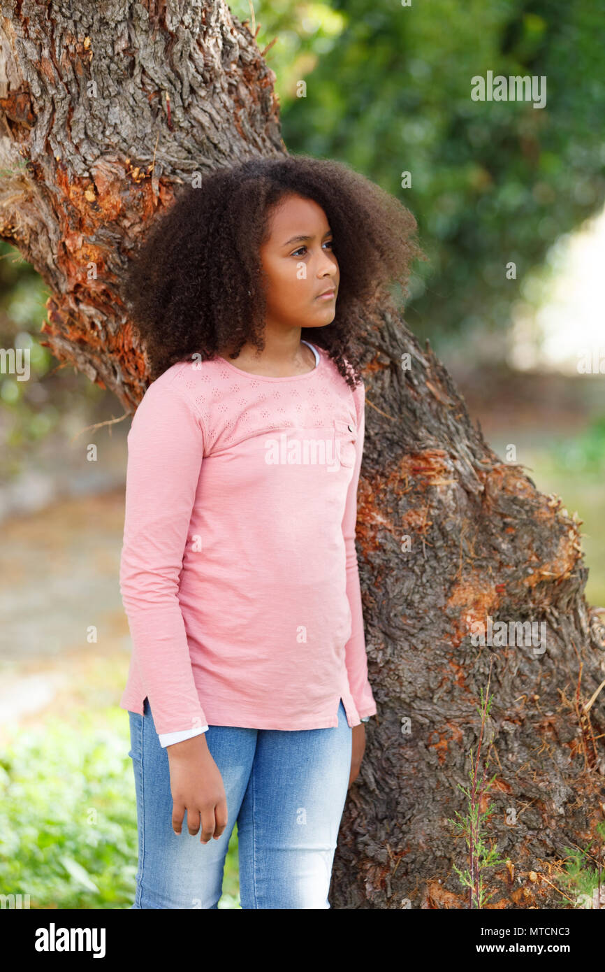 Cute African American Girl Smiling In The Street With Afro Hair