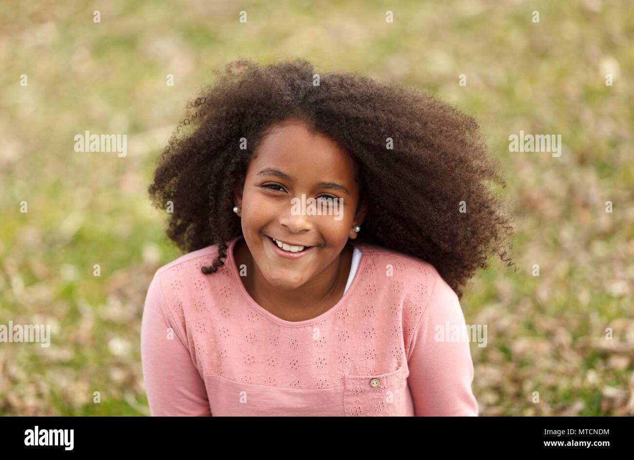 Cute African American Girl Smiling In The Street With Afro Hair