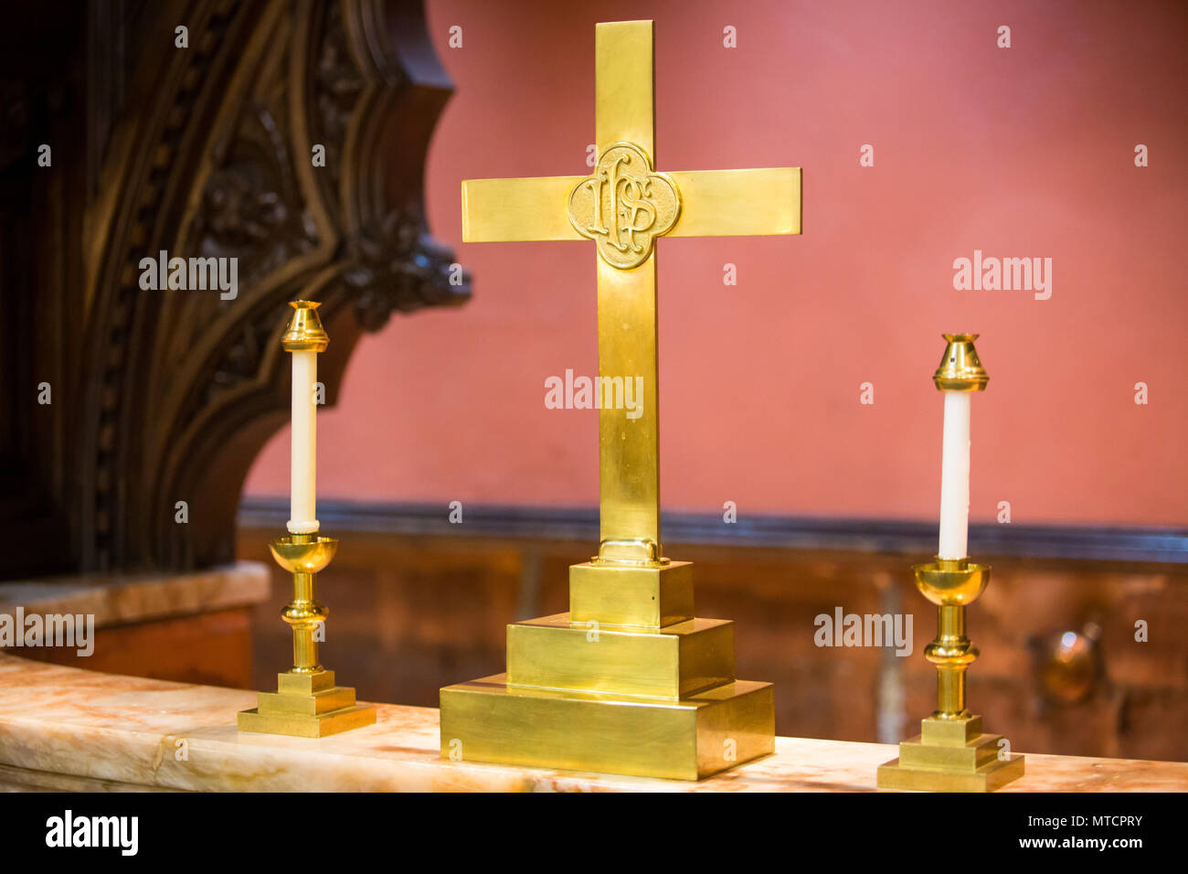 Religion symbols at church altar cross and candles indoor Stock Photo