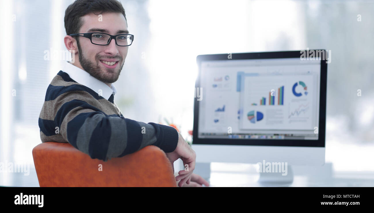 businessman analyzing financial graphs on computer Stock Photo