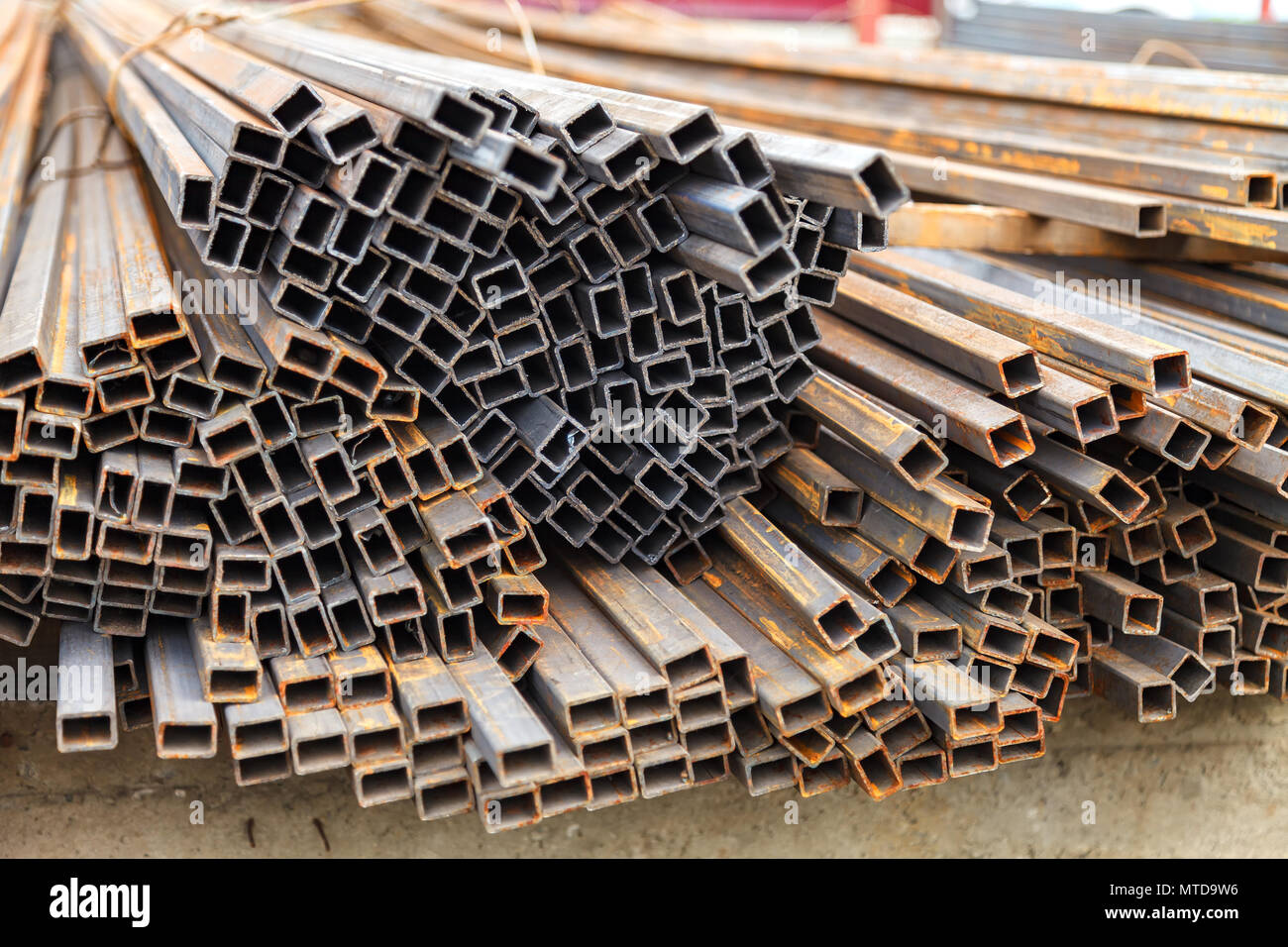 Metal square pipes connected together. The pipes are covered with rust ...
