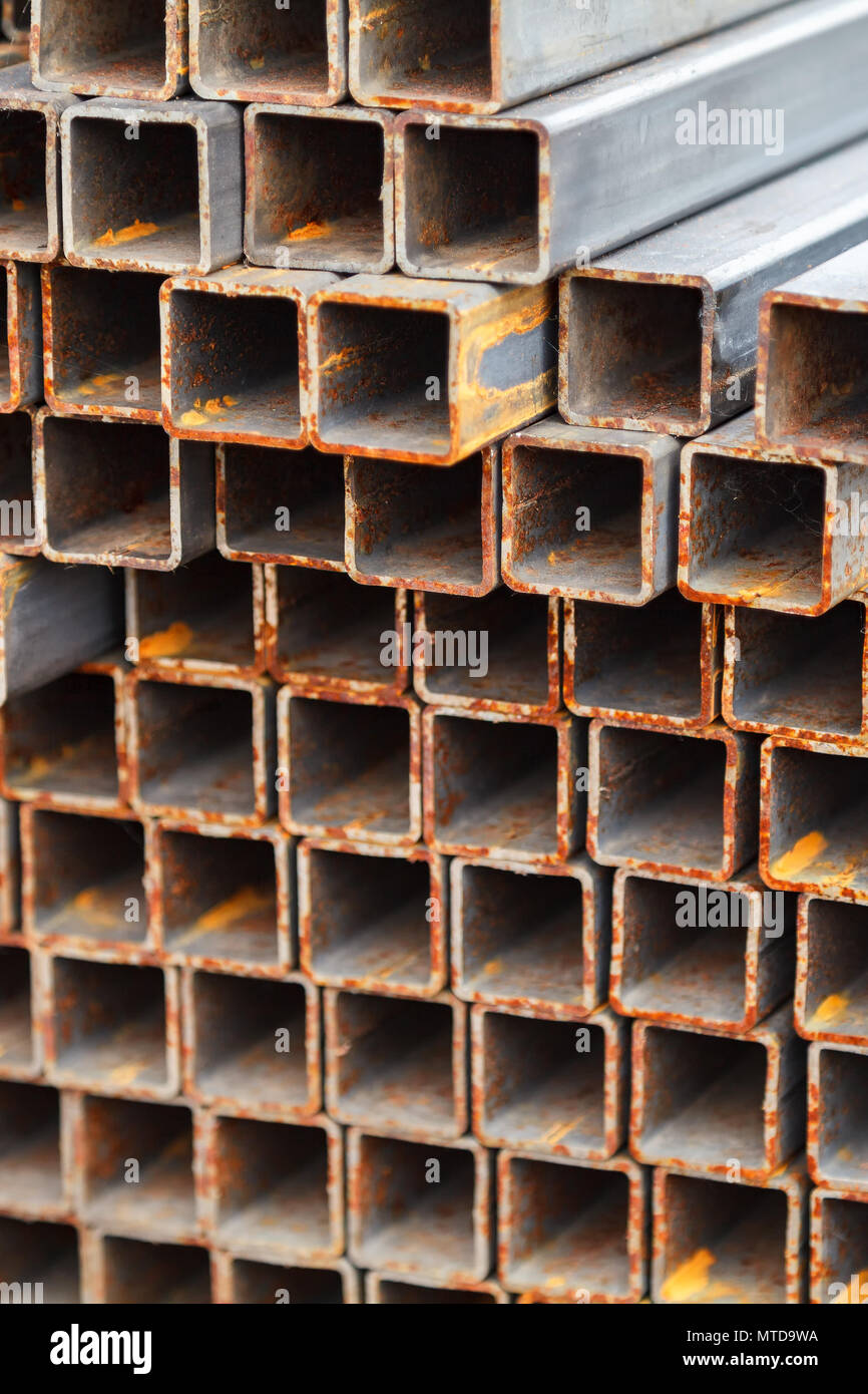 Metal square pipes connected together. The pipes are covered with rust ...