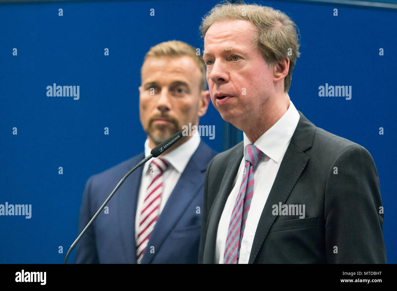 29 May 2018, Germany, Hamburg: Michael Elsner, senior public prosecutor, delivers a statement next to Jan Hieber, head of the special commission 'Schwarzer Block' (lit. black block), during a press conference in Hamburg. This morning, the police conducted raids in Italy, France, Switzerland and Italy that are associated with crimes, which had been committed during the G20 Summit in Hamburg. Photo: Malte Christians/dpa Stock Photo