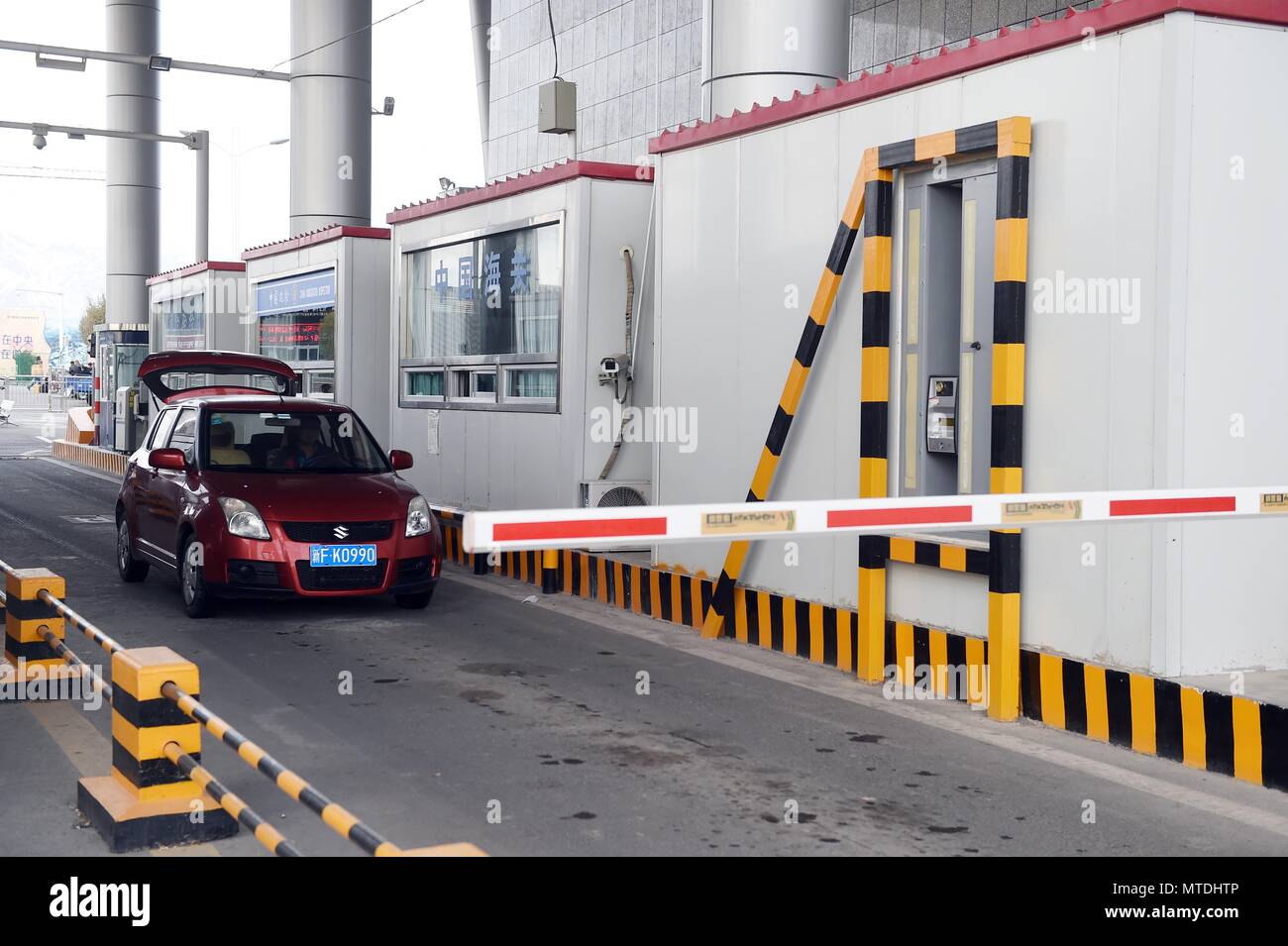 Beijing, China's Xinjiang Uygur Autonomous Region. 11th Nov, 2015. A car passes the entry and exit joint inspection passage at China-Kazakhstan Khorgos Frontier International Cooperation Center in Ili, northwest China's Xinjiang Uygur Autonomous Region, Nov. 11, 2015. The 18th Shanghai Cooperation Organization (SCO) Summit is scheduled for June 9 to 10 in Qingdao, a coastal city in east China's Shandong Province. Credit: Chen Yehua/Xinhua/Alamy Live News Stock Photo