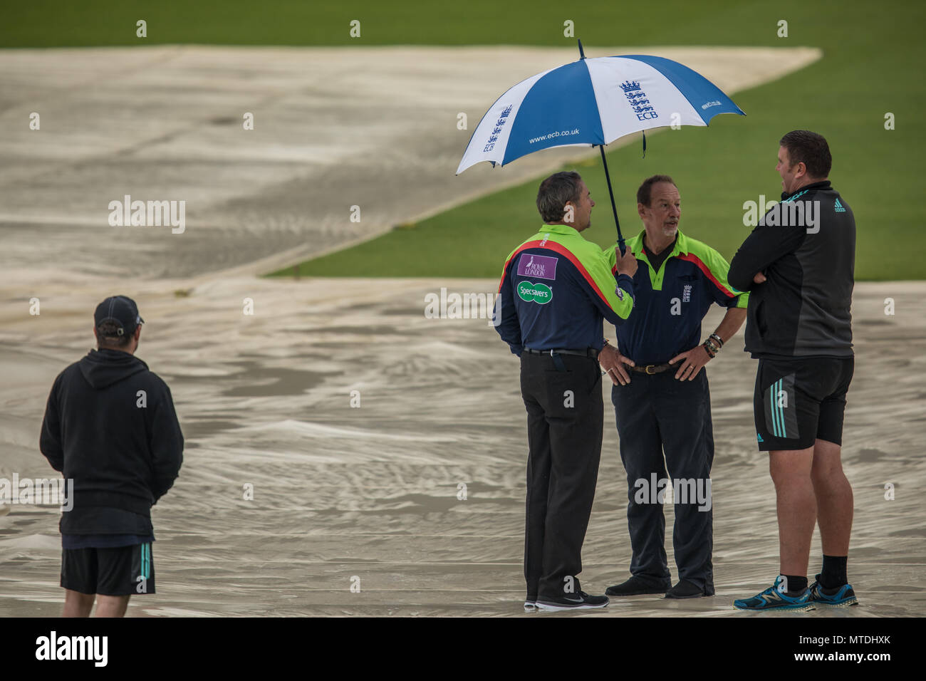 London,UK. 29 May, 2018. L-R: Umpires Richard Illingworth & Jeremy Lloyds discuss things with Surrey's Head Groundsman, Lee Fortis during a pitch inspection at the Oval. The match between Surrey and Sussex in the Royal London One-Day Cup was abandoned without a ball being bowled due to heavy rain in London. David Rowe/Alamy Live News Stock Photo
