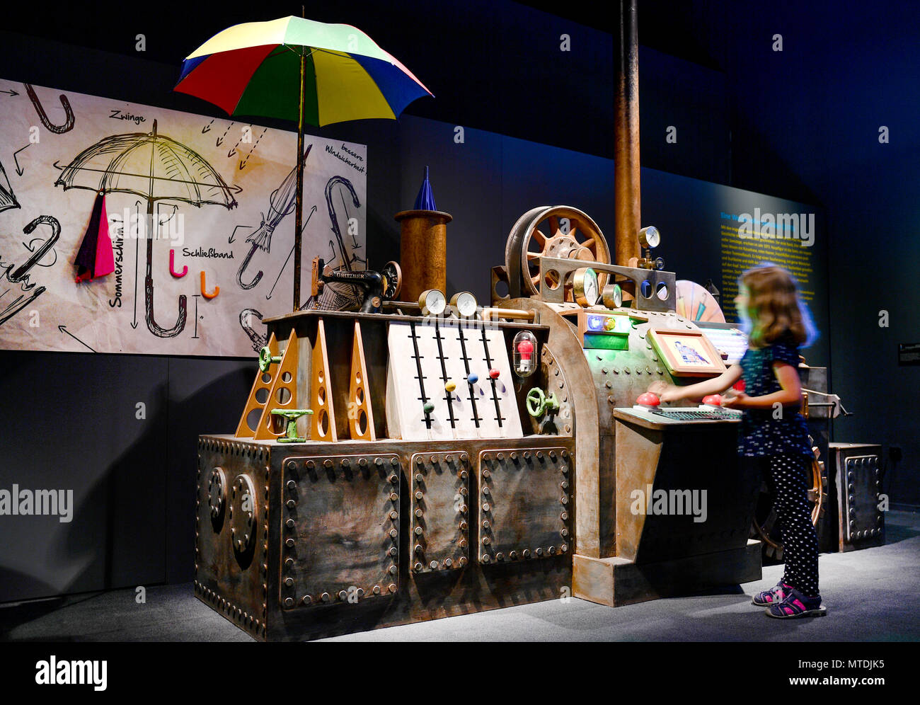 30 May 2018, Germany, Speyer: Ida stands beside a replica of the umbrella machine from the film "Sams im Glueck" (lit. "Sams in luck") at the exhibition "Das Sams und die Helden der Kinderbuecher" (lit. "Sams and the heroes of childrens' books") at the Historical Museum of Rhineland-Palatinate. The exhibition is running from 01 June 2018 to 06 January 2019. Photo: Uwe Anspach/dpa Stock Photo