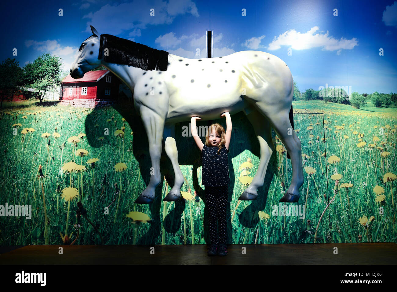 30 May 2018, Germany, Speyer: Ida holds up a replica of a horse in the area dedicated to Astrid Lindgren's creation Pippi Longstocking at the exhibition "Das Sams und die Helden der Kinderbuecher" (lit. "Sams and the heroes of childrens' books") at the Historical Museum of Rhineland-Palatinate. The exhibition is running from 01 June 2018 to 06 January 2019. Photo: Uwe Anspach/dpa Stock Photo
