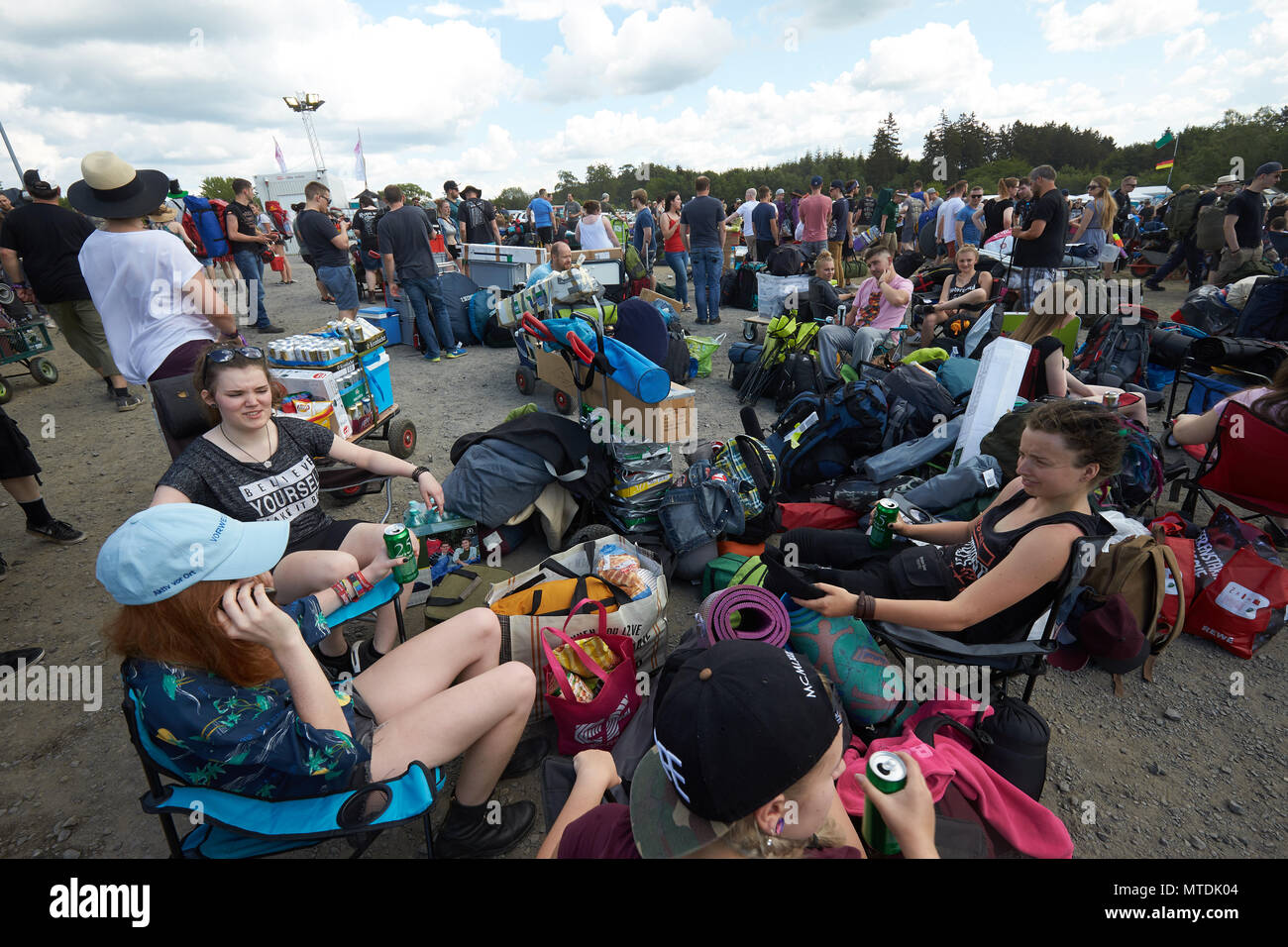 30 May 2018, Germany, Nuremberg: Rock fans arrive with heavy luggage on the camping grounds of the music festival "Rock am Ring". A total 80 bands are lined up to play