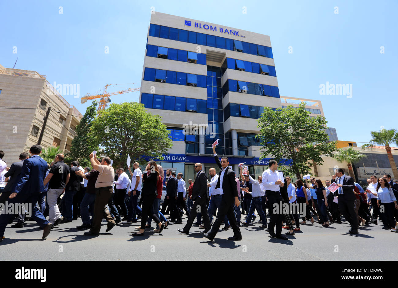 Amman, Jordan. 30th May, 2018. Jordanians protest against government's income tax draft law in Amman, the capital of Jordan, on May 30, 2018. Doctors, journalists, teachers, lawyers, pharmacists and other representatives from more than 33 associations, unions and societies in Jordan take part in a nationwide strike on Wednesday, in rejection of the government's income tax draft law which has been submitted to the parliament recently, aiming to widen the base of tax payers. Credit: Mohammad Abu Ghosh/Xinhua/Alamy Live News Stock Photo