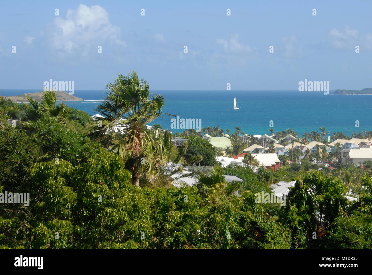 Small yacht sailing in bay, St Maarten, Caribbean Stock Photo