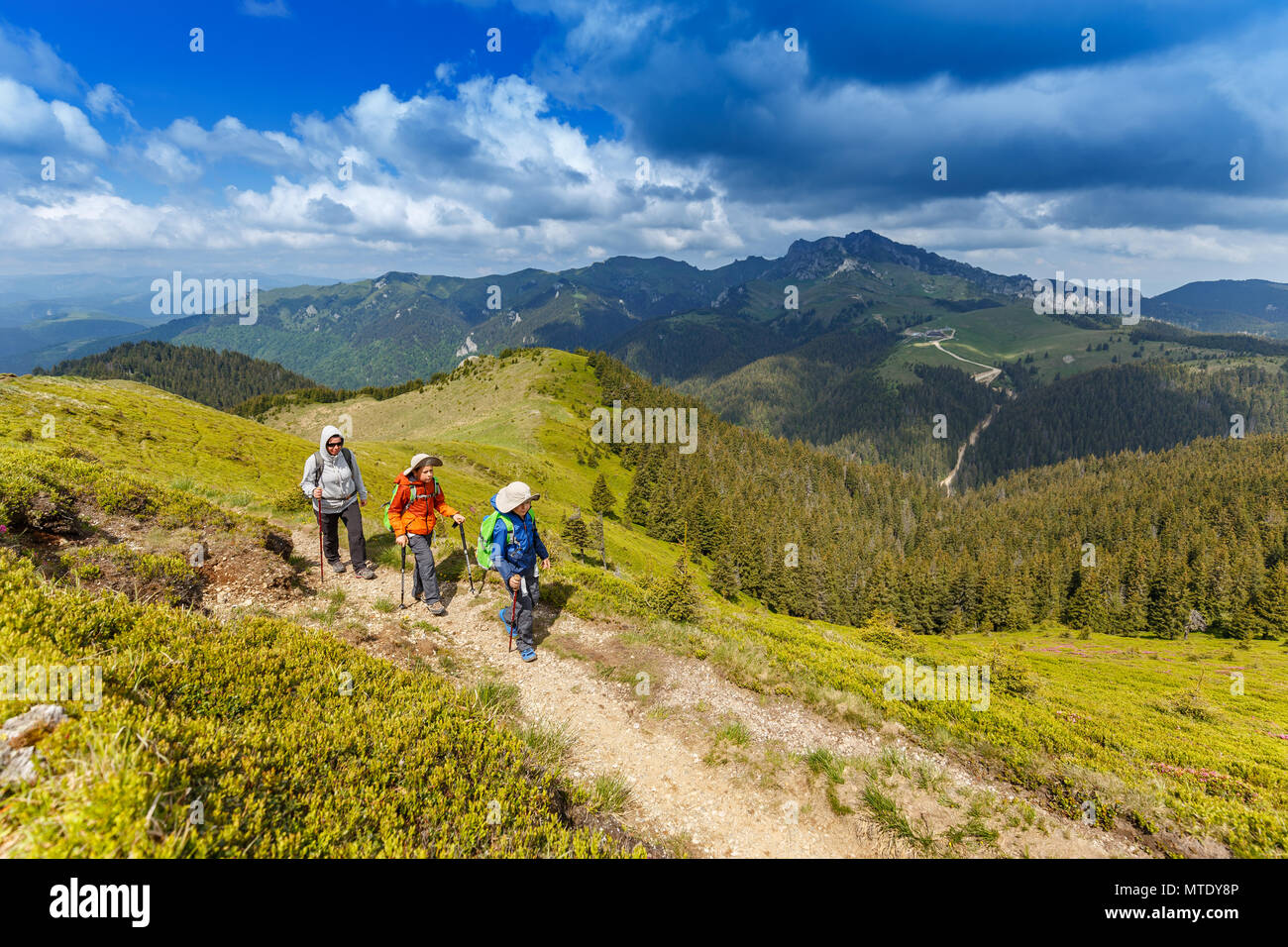 Woman with her children hiking in the mountain Stock Photo