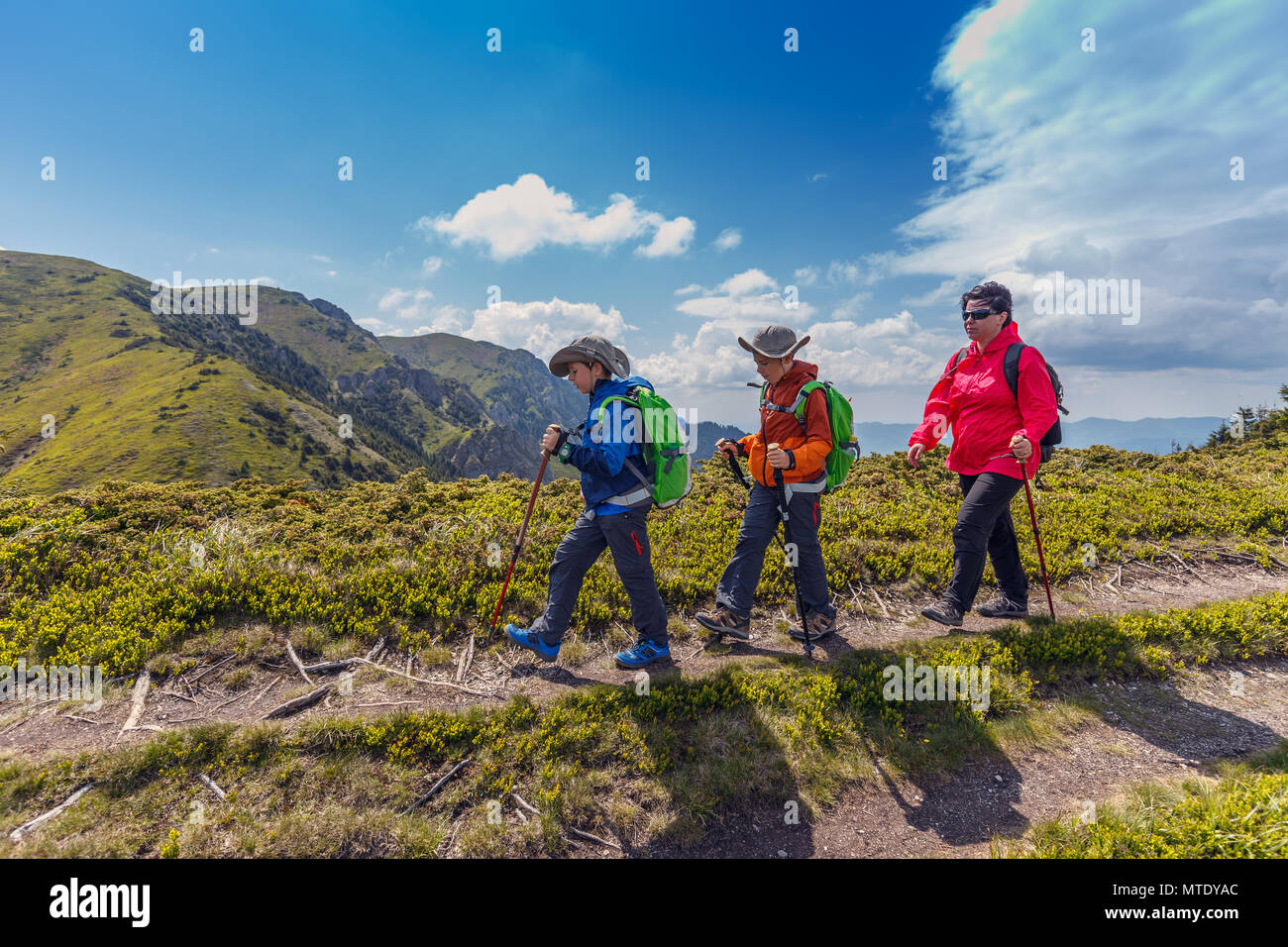 Woman with her children hiking in Romanian mountains, recreation activity Stock Photo