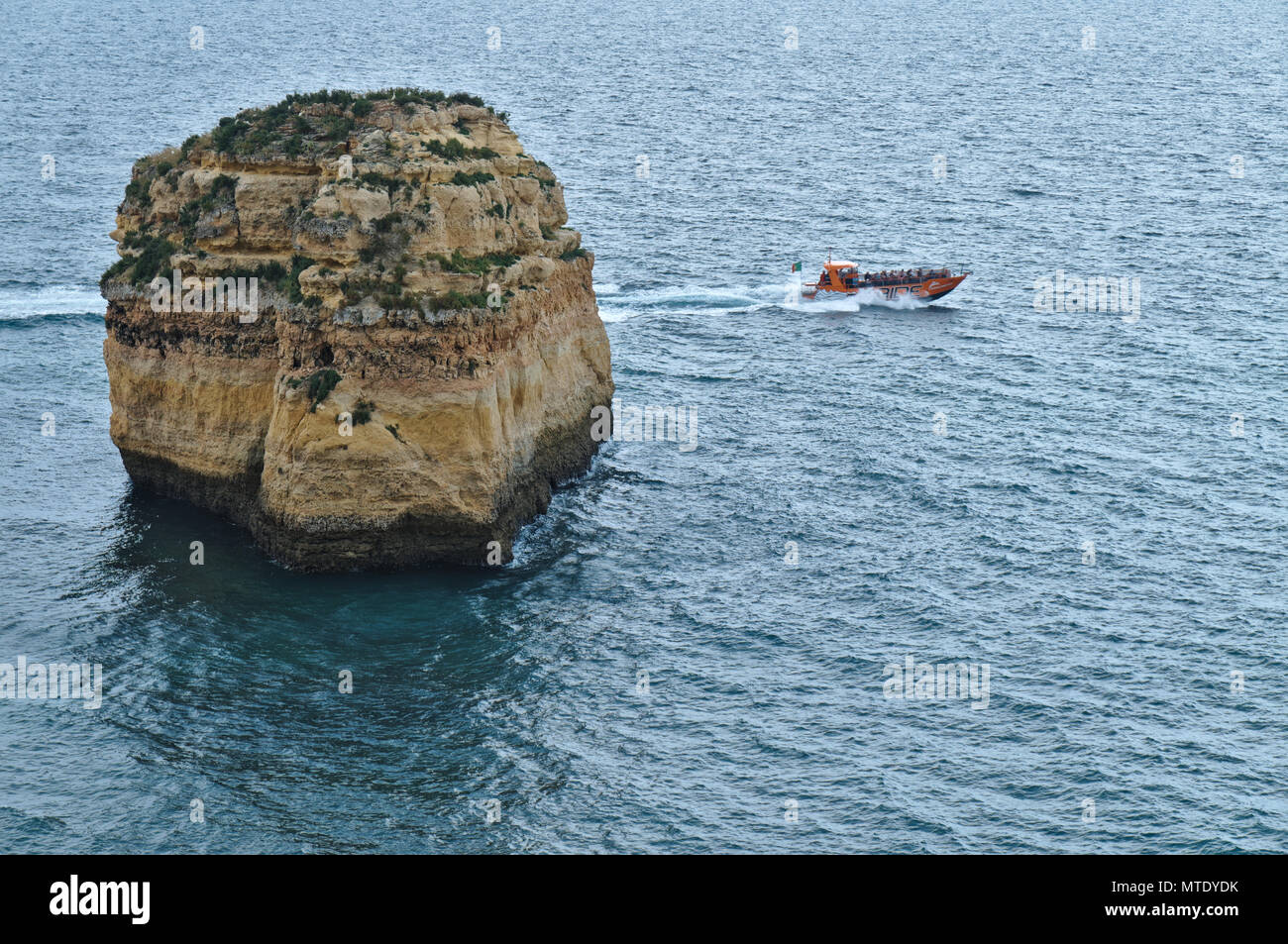 Boat cave tours along the coast of Lagoa, Algarve, Portugal Stock Photo