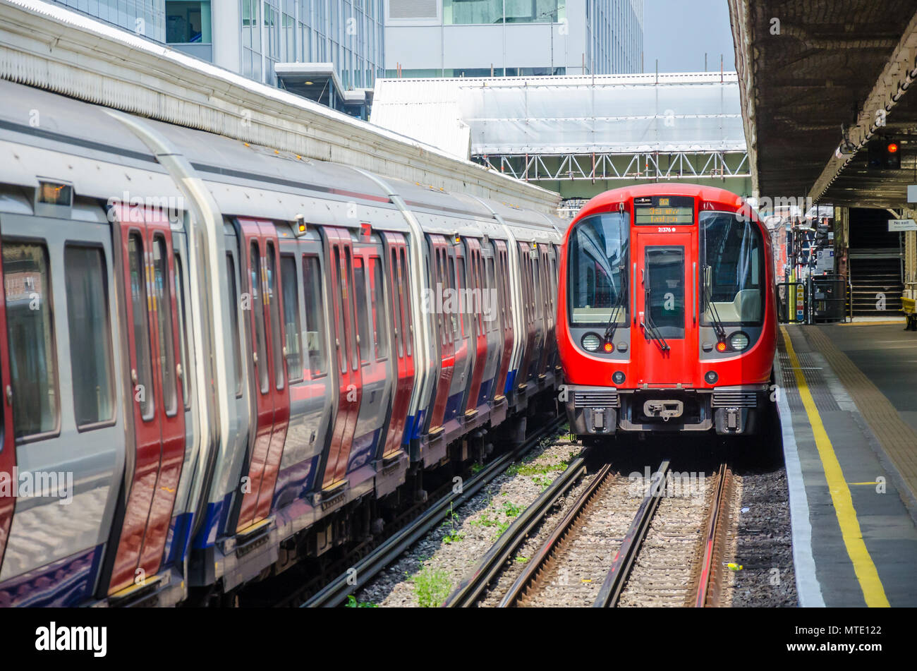 A train departs from the platform at Hammersmith London Underground Station. Stock Photo