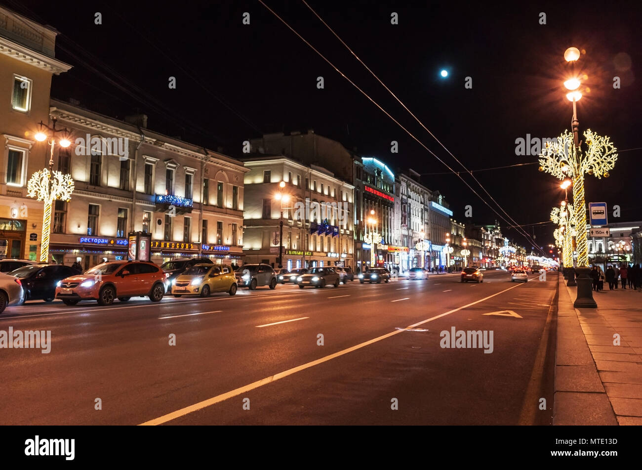 Saint-Petersburg, Russia - December 27, 2015: Nevsky Prospect at night with Christmas illumination, ordinary people walk on the street Stock Photo