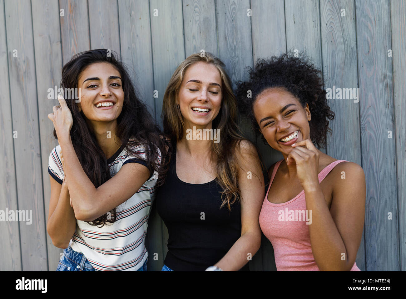 Three beautiful girls standing outdoors and having fun Stock Photo