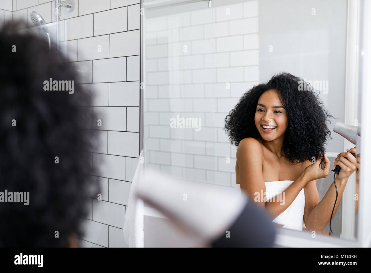 Woman drying hair in mirror hi-res stock photography and images - Alamy