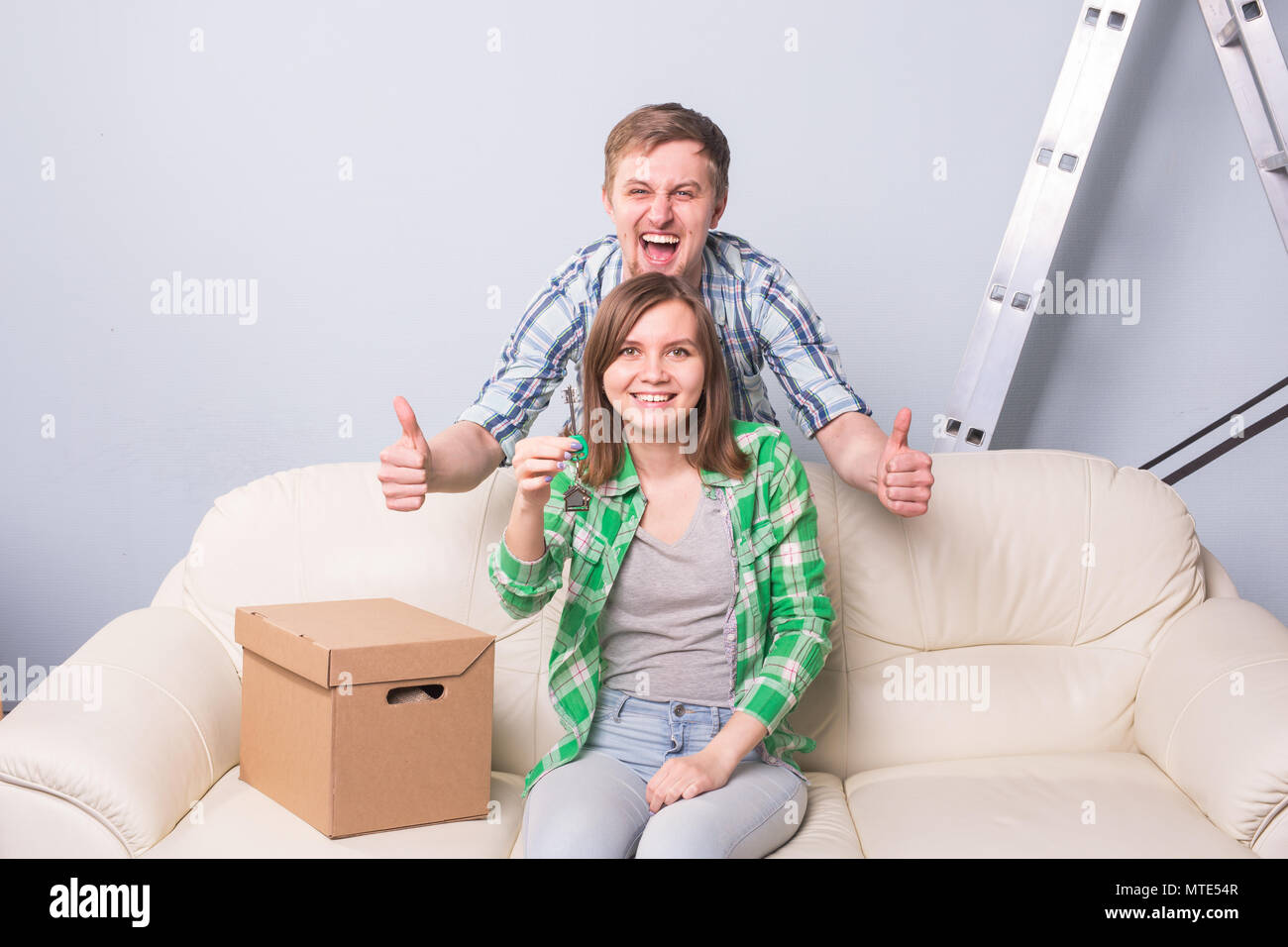 Happy couple in their new home holding key Stock Photo - Alamy