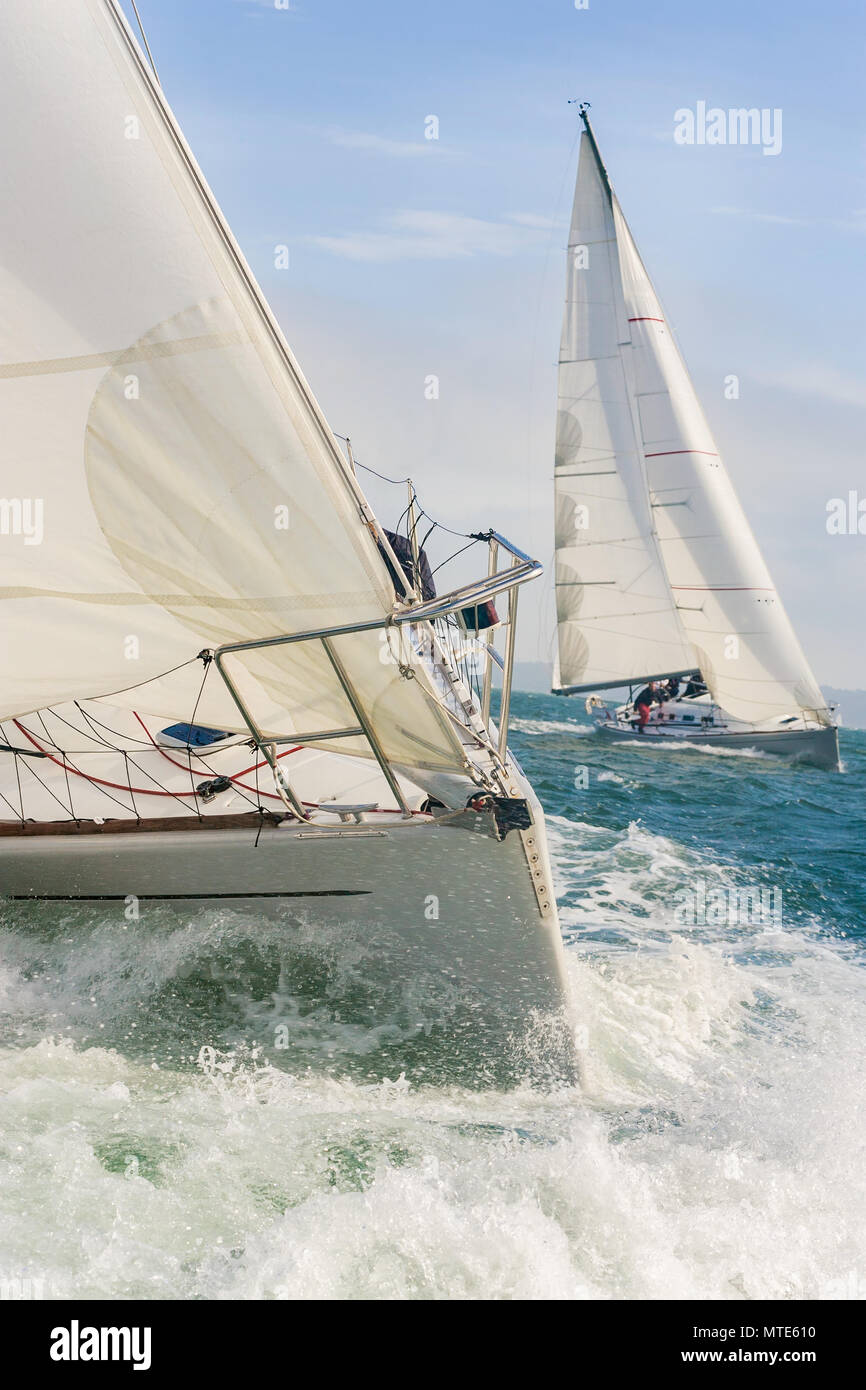 Two sailing boats, sailboats or yachts racing at sea Stock Photo