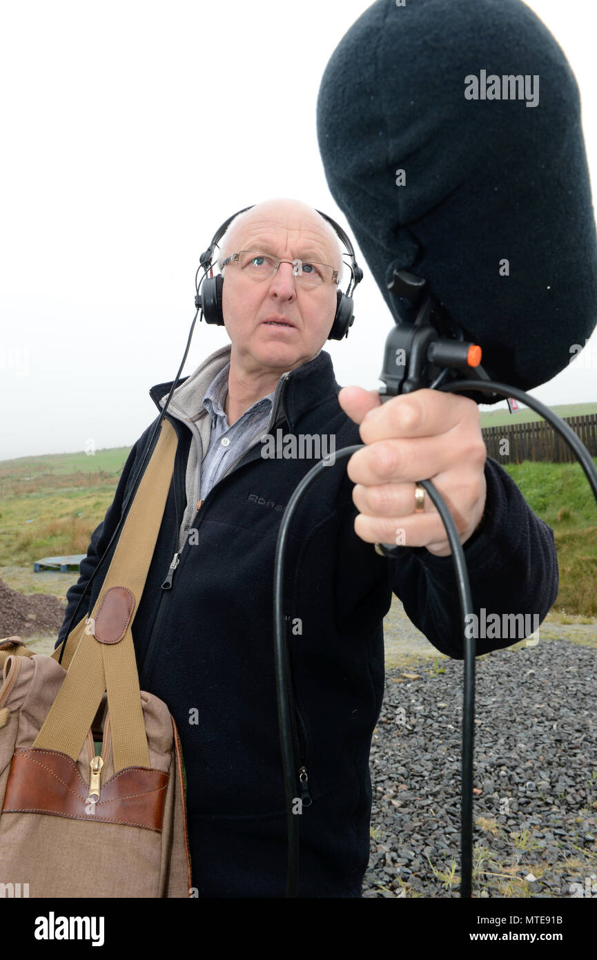 Chris Watson is a sound recordist who specialises in natural history and has recorded for the BBC here he is holding a microphone with headphones Stock Photo