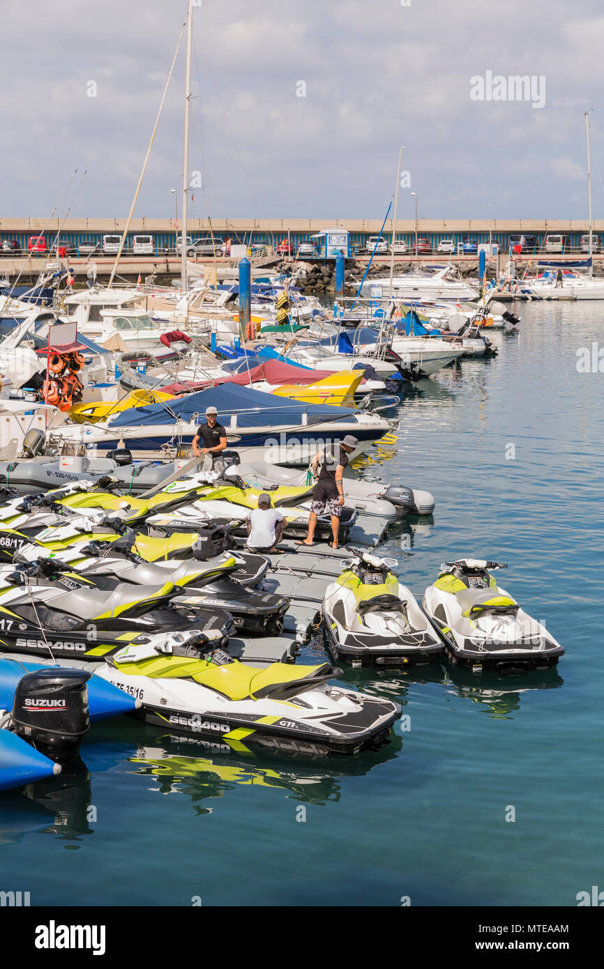 Boats and jetskis at moorings in the Puerto Colon marina, Playa de Las Americas, Tenerife, Canary Islands, Spain Stock Photo