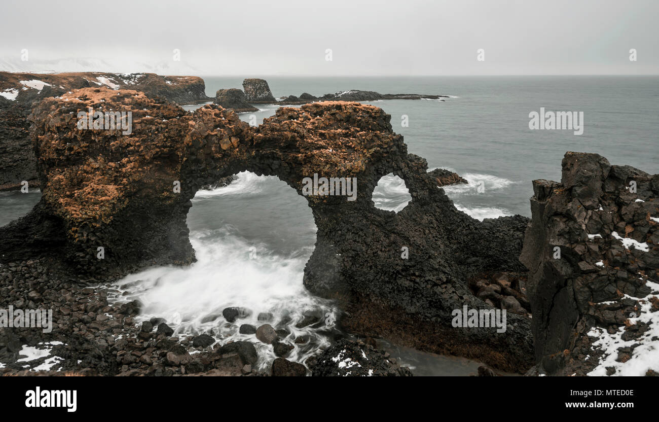 Gat Velcro, rock arch in the sea, waves at the sea, bad weather, bulb exposure, West Iceland, Iceland Stock Photo