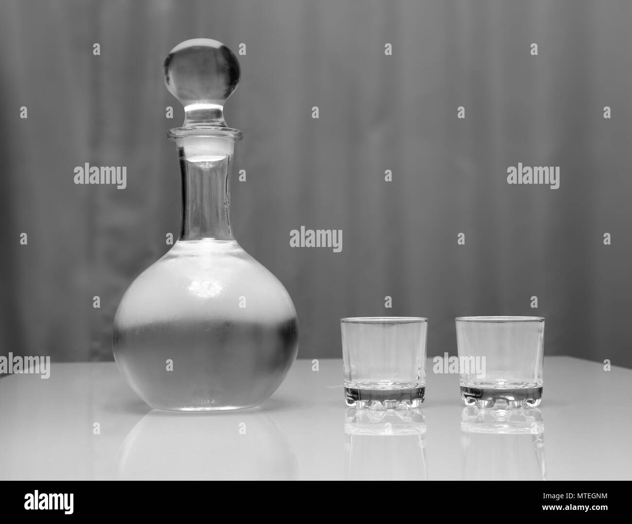 decanter and two glasses with vodka standing on table Stock Photo