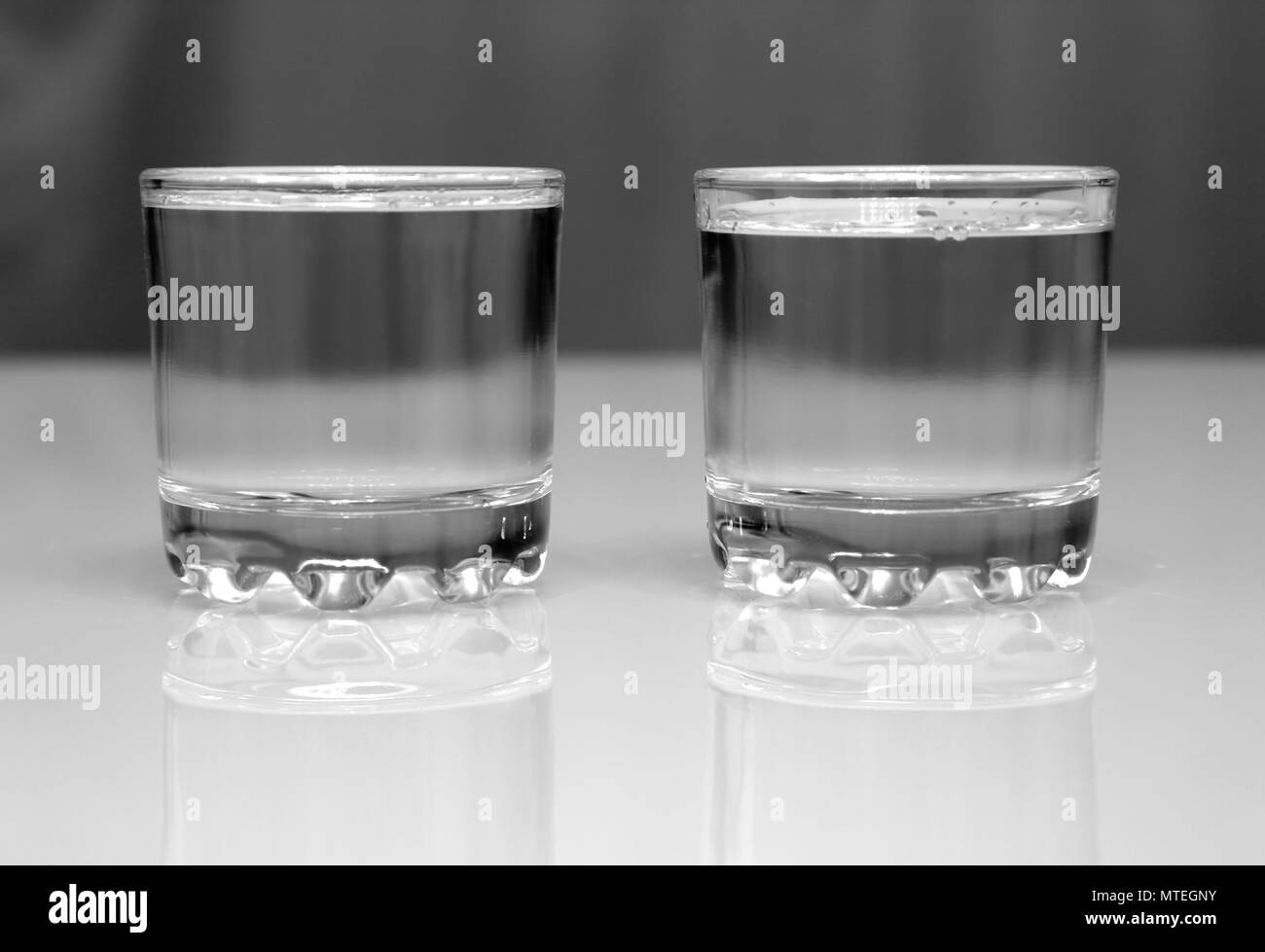 two glasses with vodka on table Stock Photo