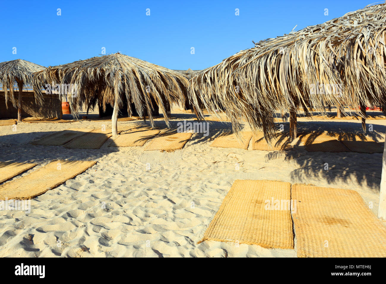umbrellas and mats on the beach Stock Photo Alamy