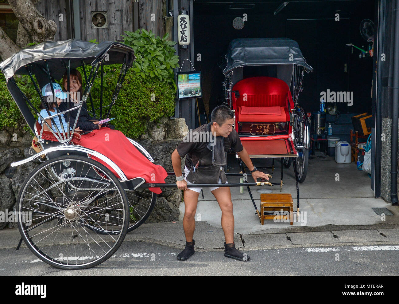 Kyoto, Japan - 24 July 2016. Tourists rides a rickshaw at Arashiyama ...