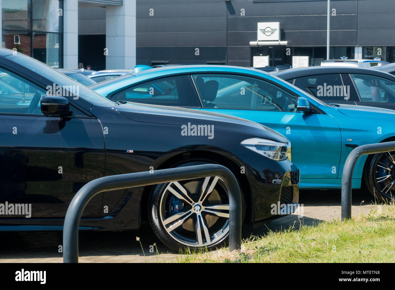 Close up of BMW cars for sale on a showroom forecourt, Marshall, Bournemouth, Dorset, United Kingdom Stock Photo