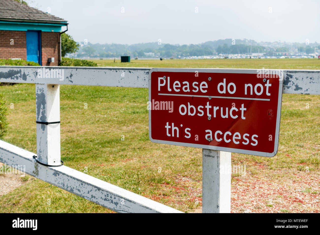 Please do not obstruct this access, British red notice on a gate in Poole, Dorset, United Kingdom Stock Photo