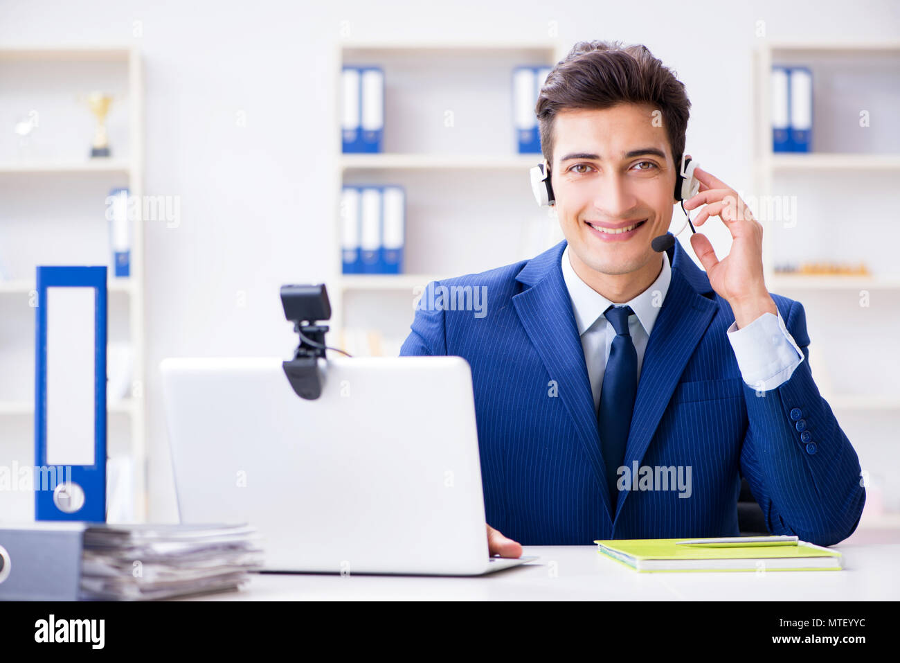 Young help desk operator working in office Stock Photo Alamy