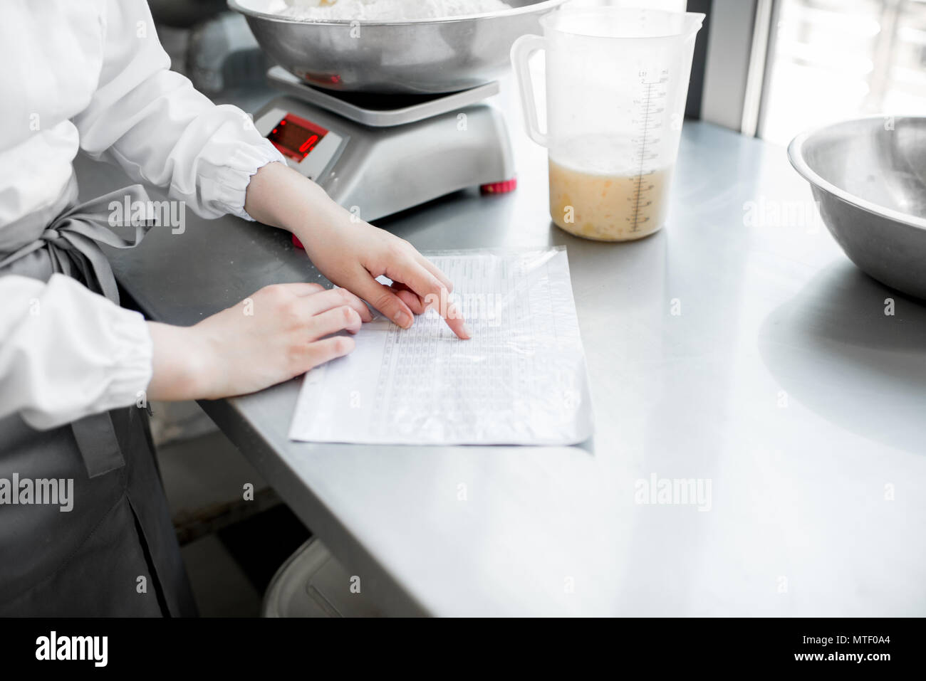 Looking on the technological card baking pastry at the manufacturing, close-up view Stock Photo