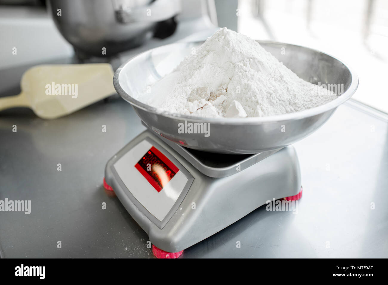 https://c8.alamy.com/comp/MTF0AT/weighing-flour-for-baking-with-professional-scales-at-the-manufacturing-close-up-view-MTF0AT.jpg