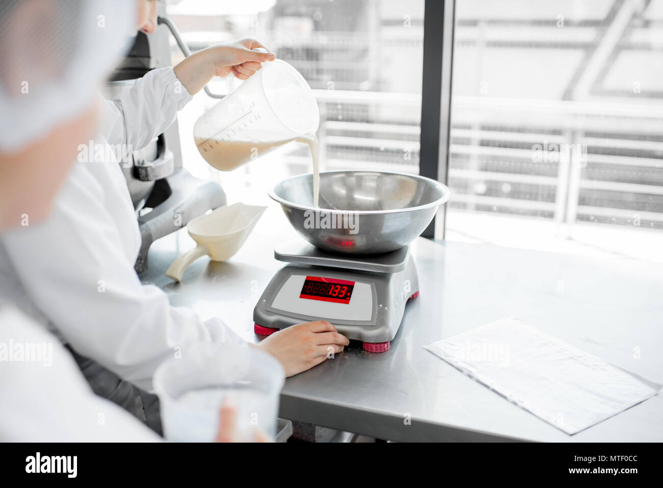 Weighing ingredients for baking at the manufacturing Stock Photo