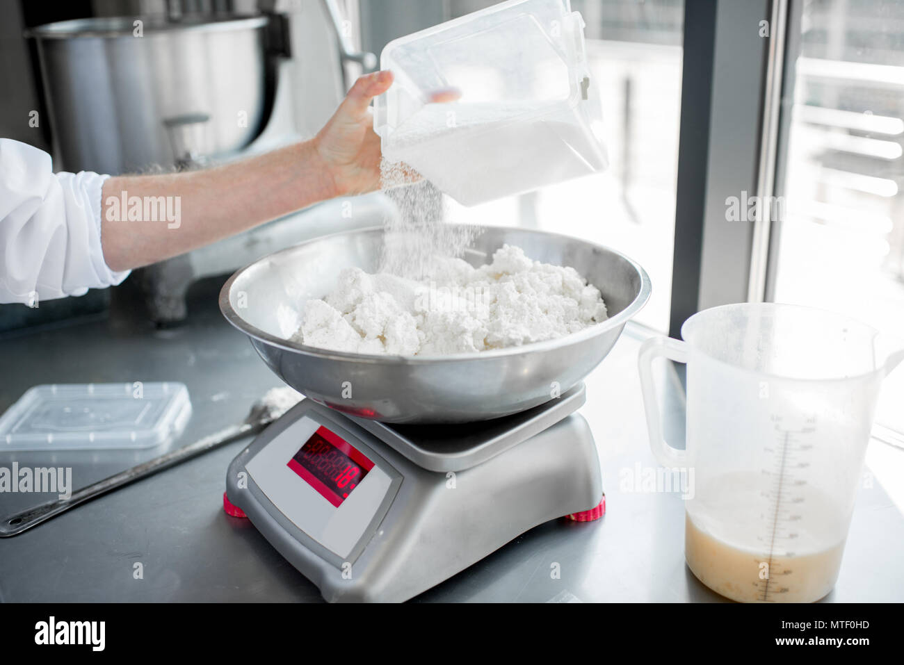 Weighing ingredients for baking with professional scales Stock Photo
