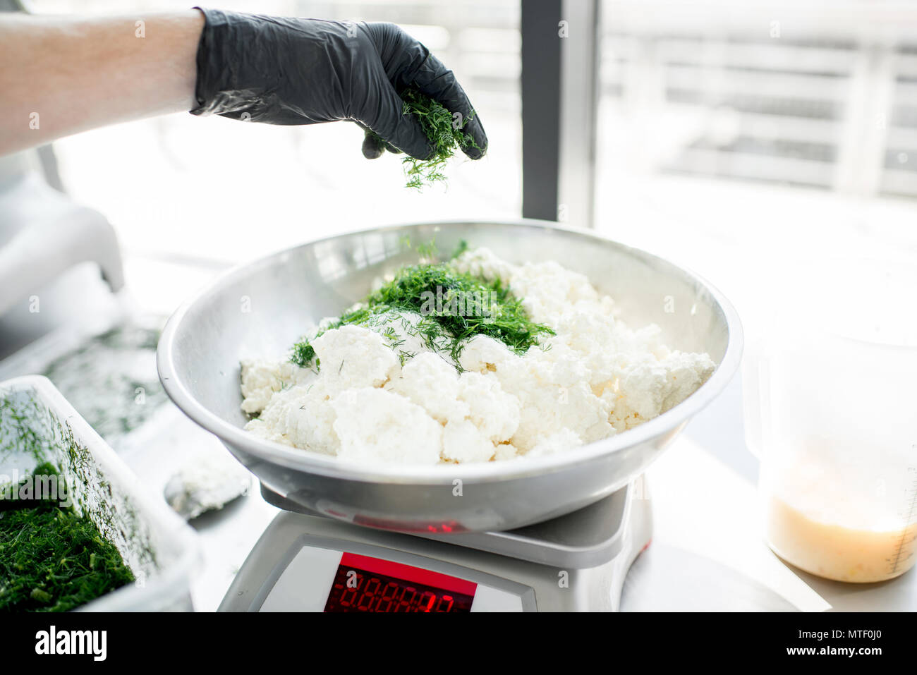 Weighing ingredients for baking with professional scales Stock Photo