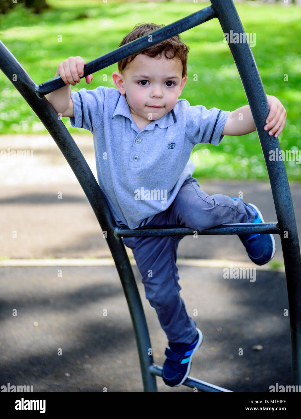 Youg boy on a park climbing frame Stock Photo