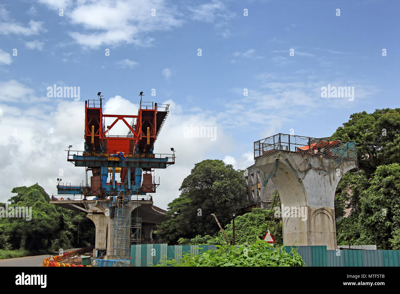Construction of deck of elevated road by joining together precast segments made of concrete over columns using huge launching girder,. Stock Photo