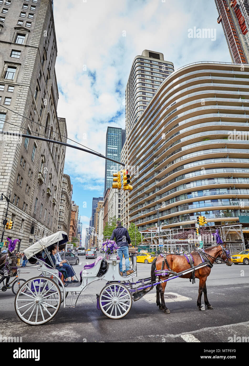 New York City, USA - May 26, 2017: Horse carriage ride by the Central Park. It is one of the best ways for tourists to enjoy the beauty of the park. Stock Photo