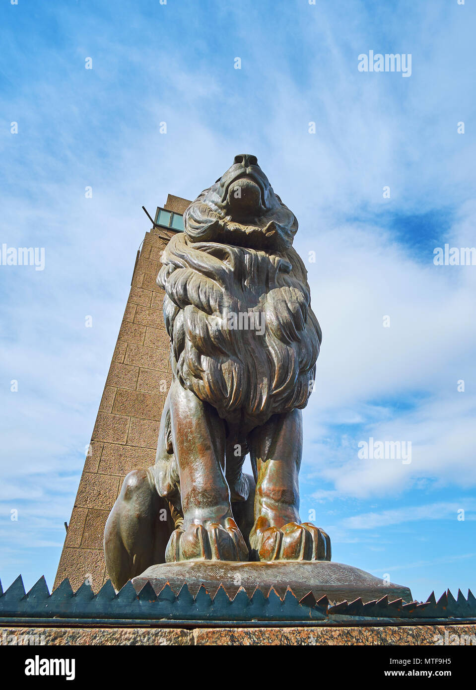 The massive statue of lion decorates the Qasr El Nil bridge, connecting Cairo Downtown with Gezira Island, Egypt. Stock Photo