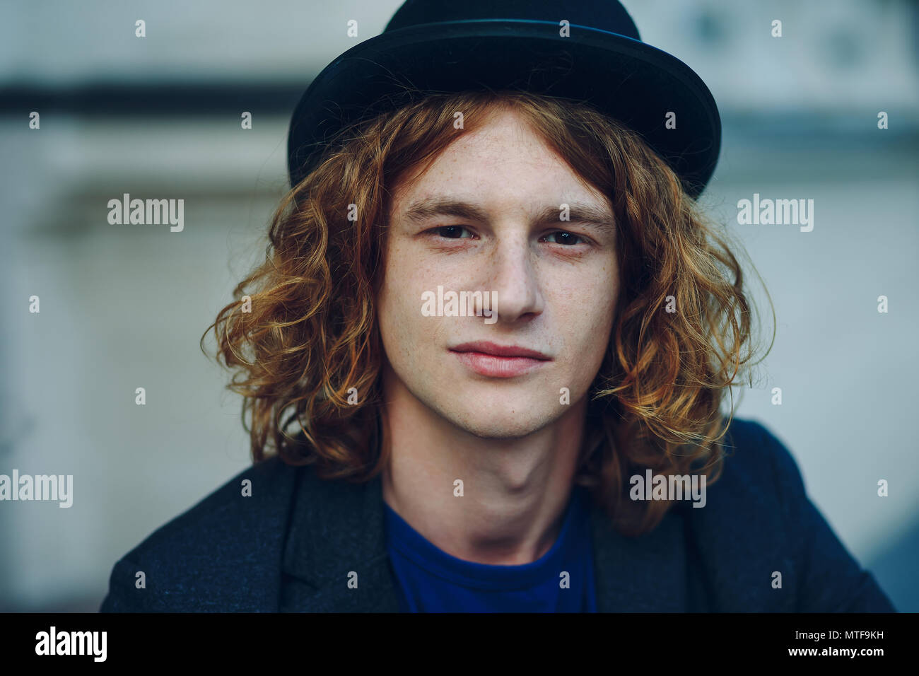 Fashion Portrait Of Young Reddish Man With Long Curly Hair