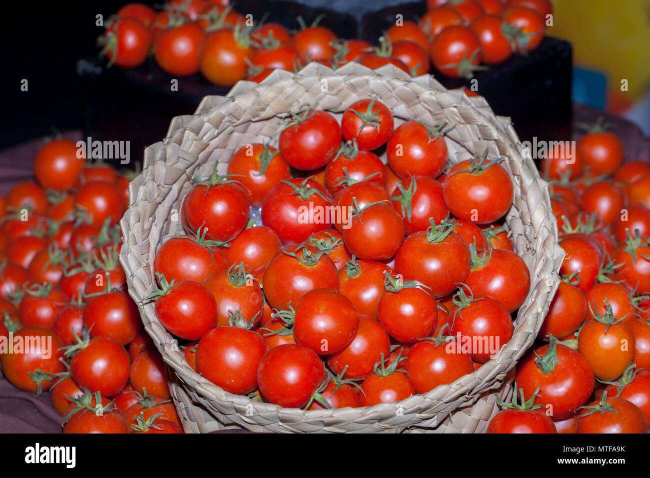 ripe tomatoes in a stall with basket Stock Photo - Alamy