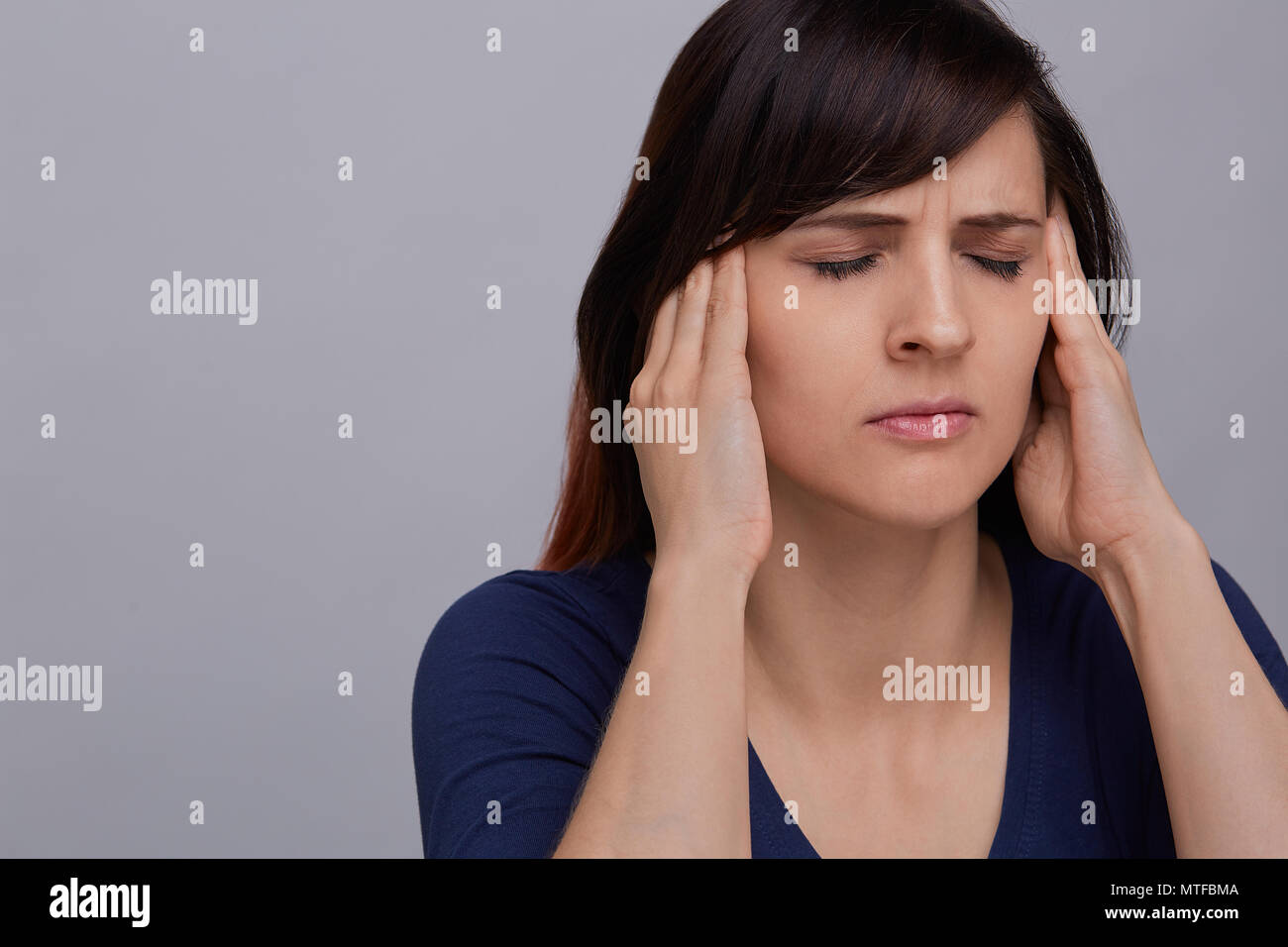 Woman fingers on temples hi-res stock photography and images - Alamy
