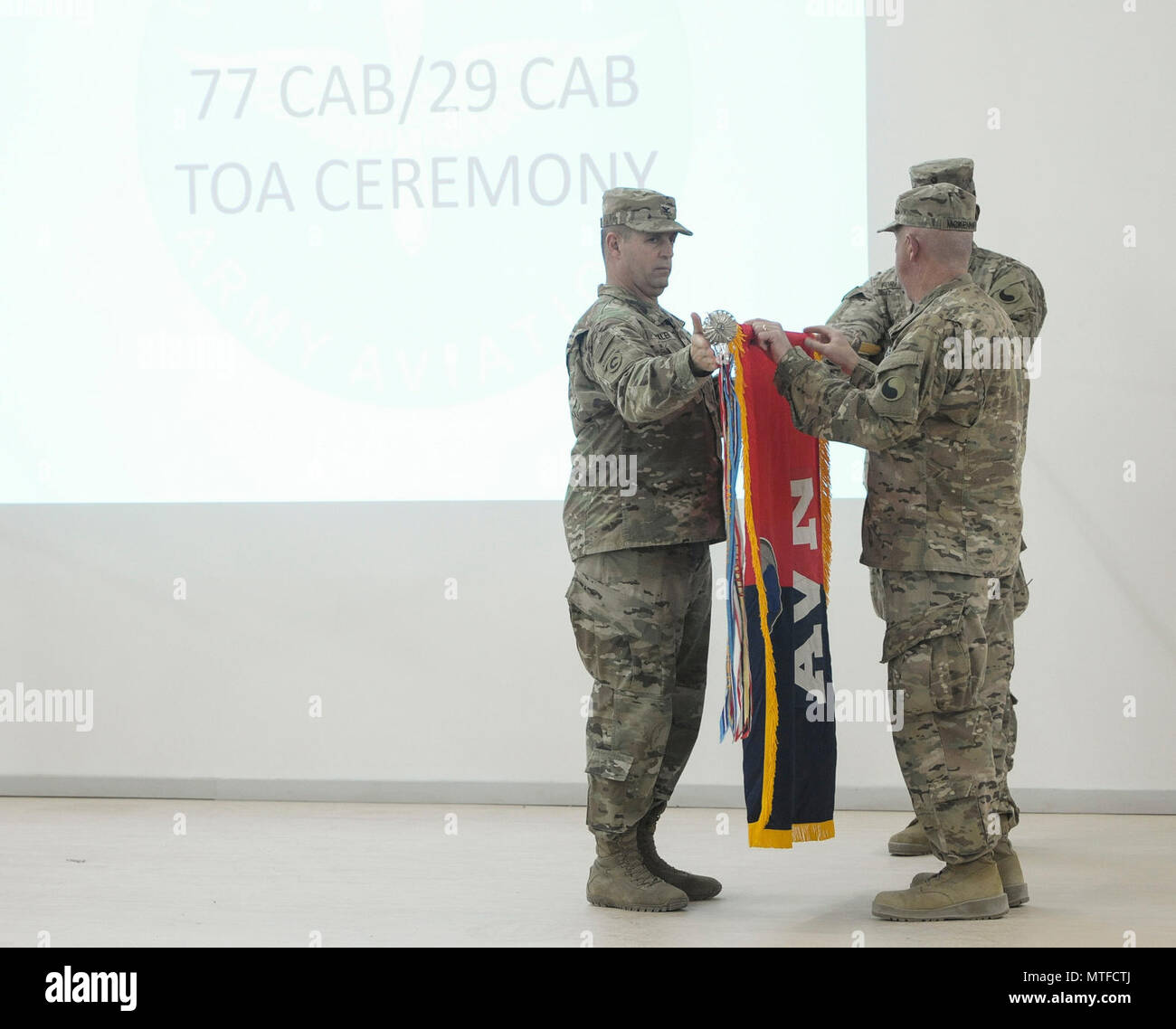 Col. Mark Beckler and Command Sgt. Major Steven McKenna unveiled the 29th Combat Aviation Brigade Colors during their Transfer of Authority Ceremony on April 23. The TOA signals the transference of responsibility for theater aviation operations from the outgoing 77th CAB. Camp Buehring, Kuwait (US. Army Stock Photo