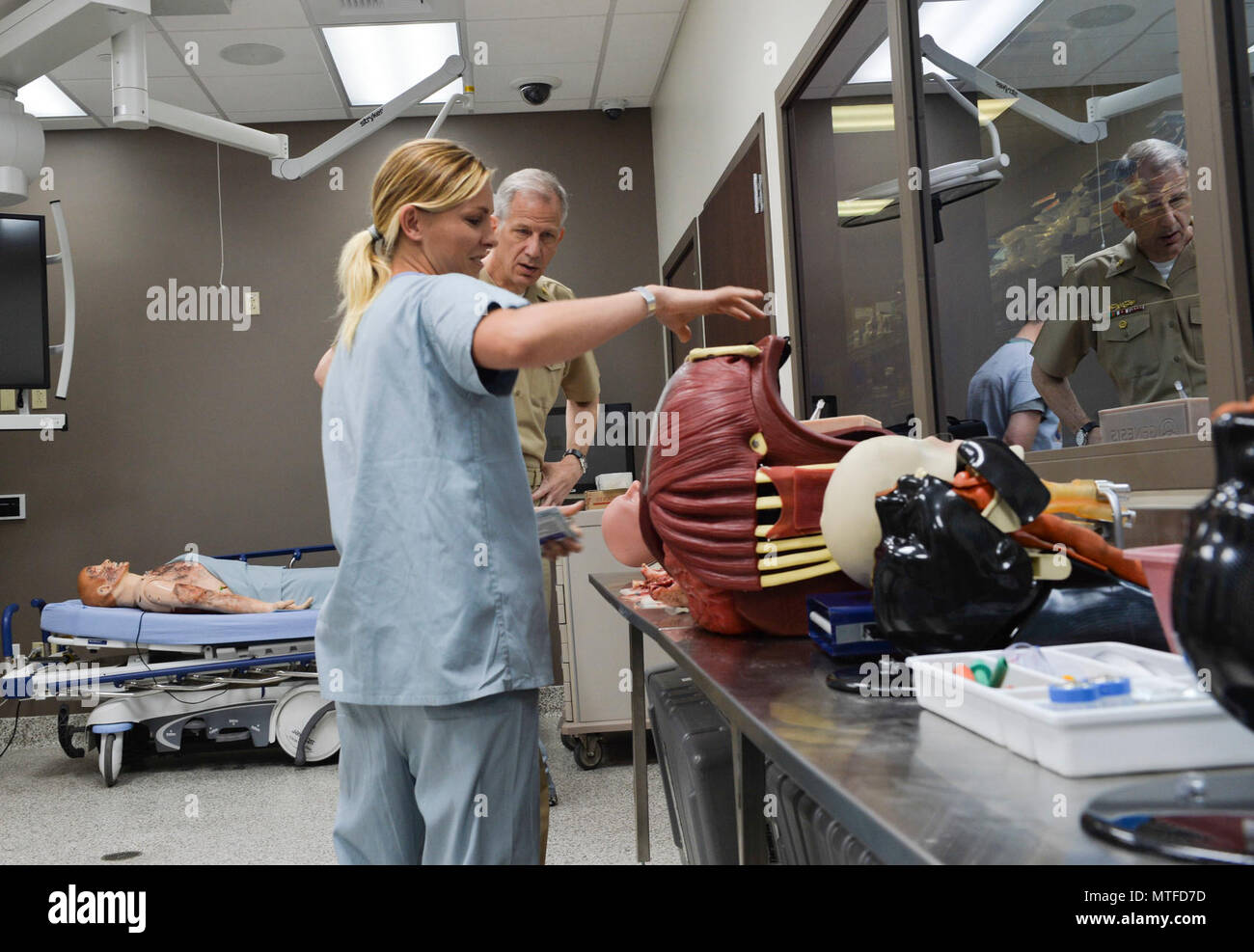 SAN DIEGO (April 24, 2017) Jennifer Deveraux (left), department manager, Naval Medical Center San Diego (NMCSD) Surgical Simulation Center, Commander, Navy Medicine West, Rear Adm. Paul Pearigen. Pearigen toured NMCSD and visited the Medical and Surgical Sim Center, Bio Skills Training Center and Emergency Department before holding an Admiral’s call and answering Sailors’ questions. Stock Photo